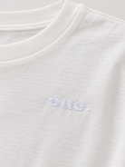 Studio Core Crop White — תקריב הרקמה ומרקם הבד